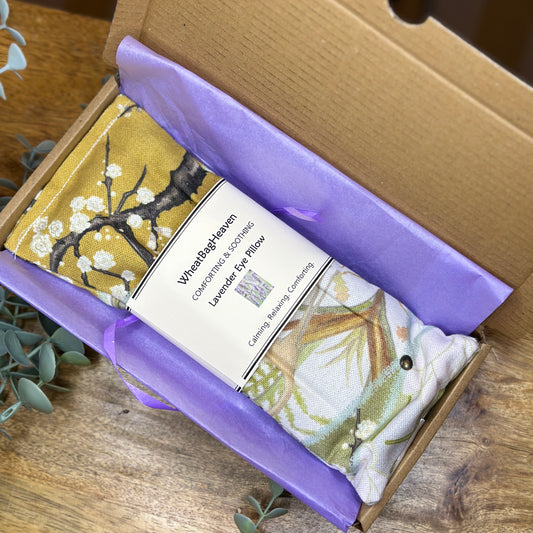 chateaux collection flaxseed eye pillow with English lavender, laid on tissue in a letterbox sized postal box from WheatBagHeaven
