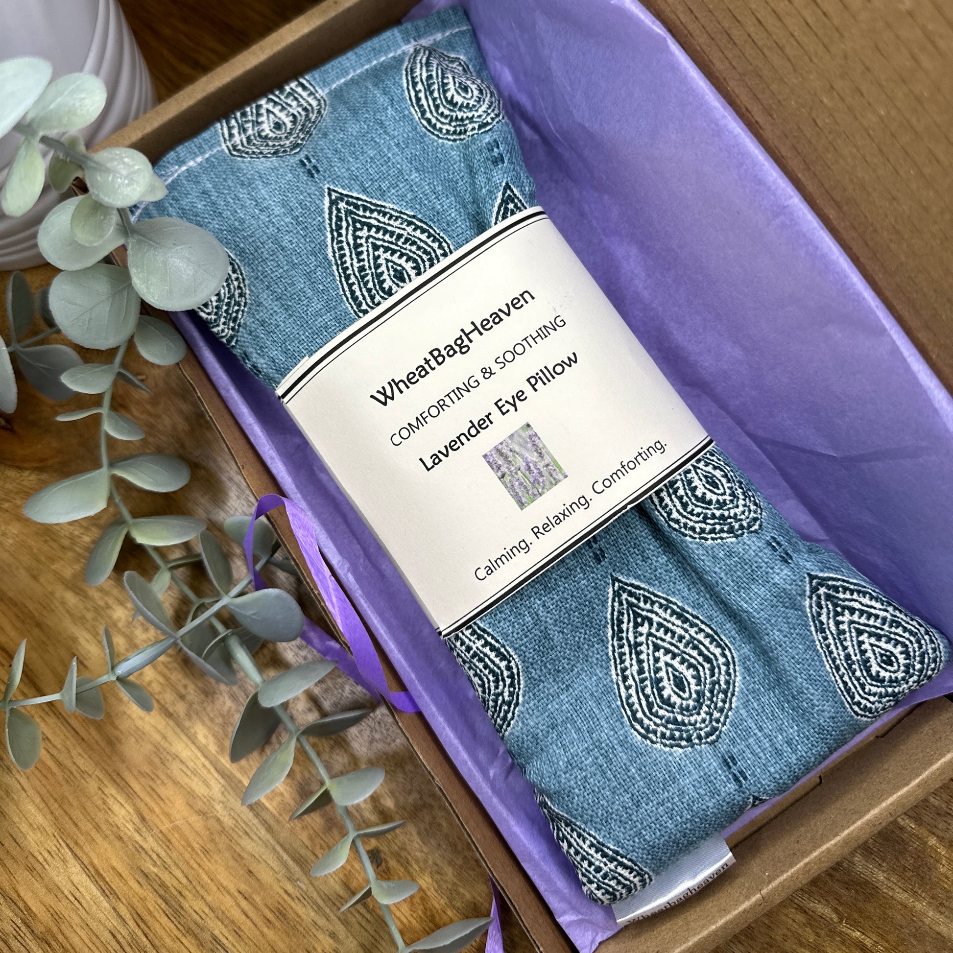 closer look at lavender scented eye pillow in a lovely teal blue print. packaged in a letterbox sized postal bix with tissue