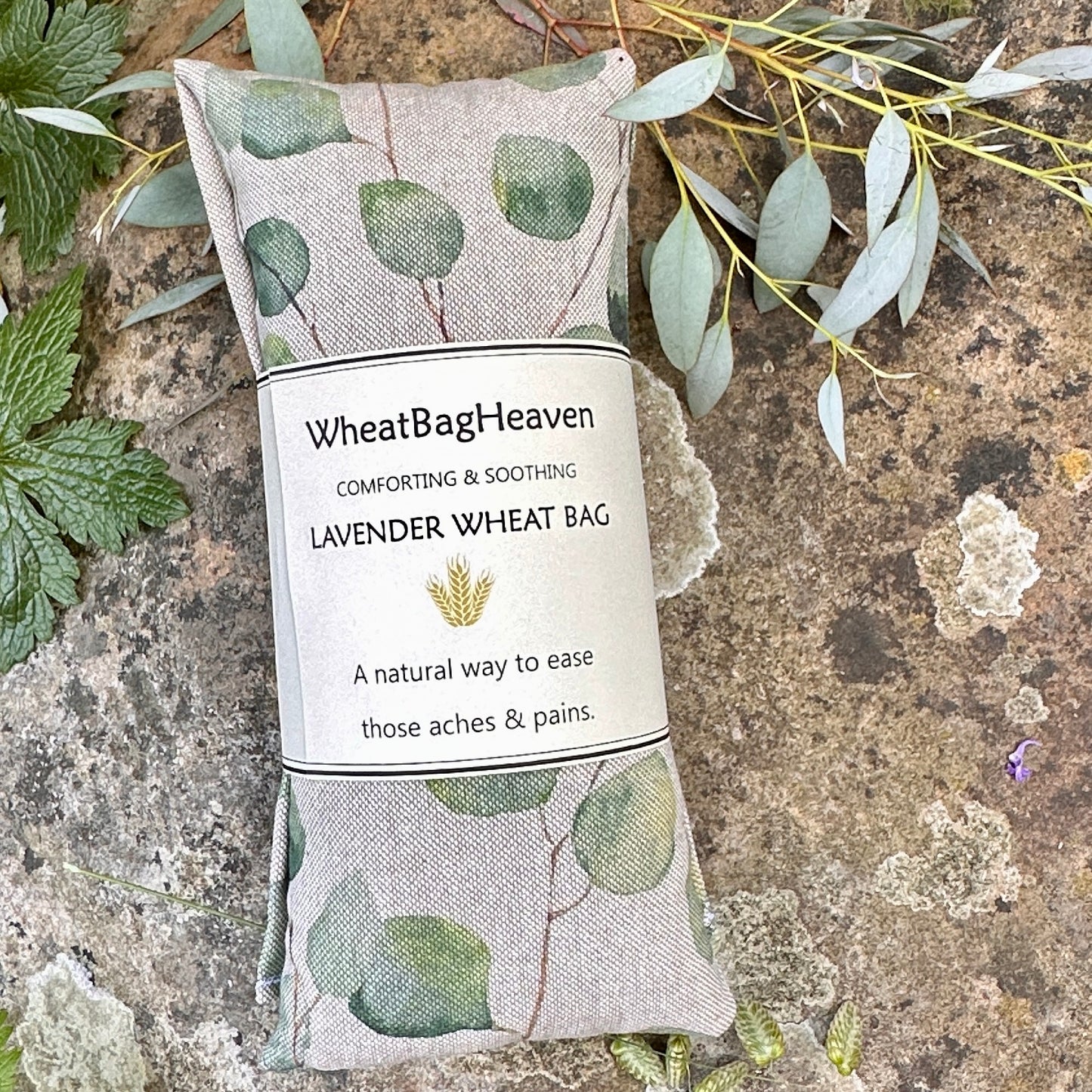 Practical hot/cold compress wheat bag neck wrap in Lovely green leaves of eucalyptus, printed on a beige background cotton linen fabric, handmade at wheatbagheaven.com and ready to post
