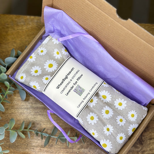 letterbox gift, daisy printed eye pillow with flaxseed and lavender to aid relaxation and restful sleep. wrapped in lilac tissue and ribbon tied