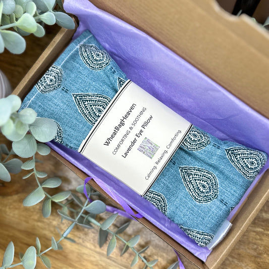 teal blue yoga meditation eye pillow for wellbeing. wrapped in tissue in its postal box