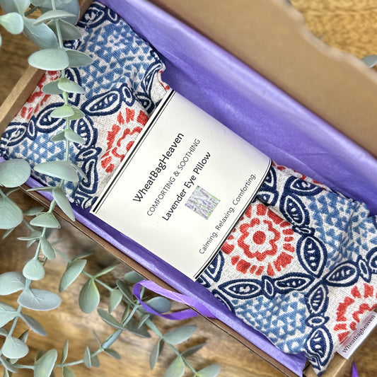 yoga meditation eye pillow in a blues/red Mandela print wrapped in lilac tissue in postal box