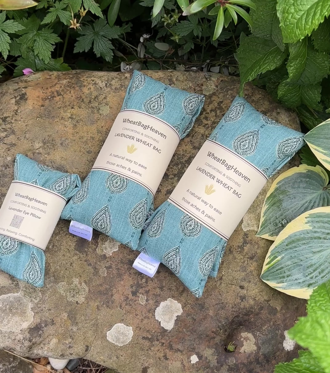 short video of WheatBagHeaven teal blue eye pillows and wheat bags with a garden backdrop 