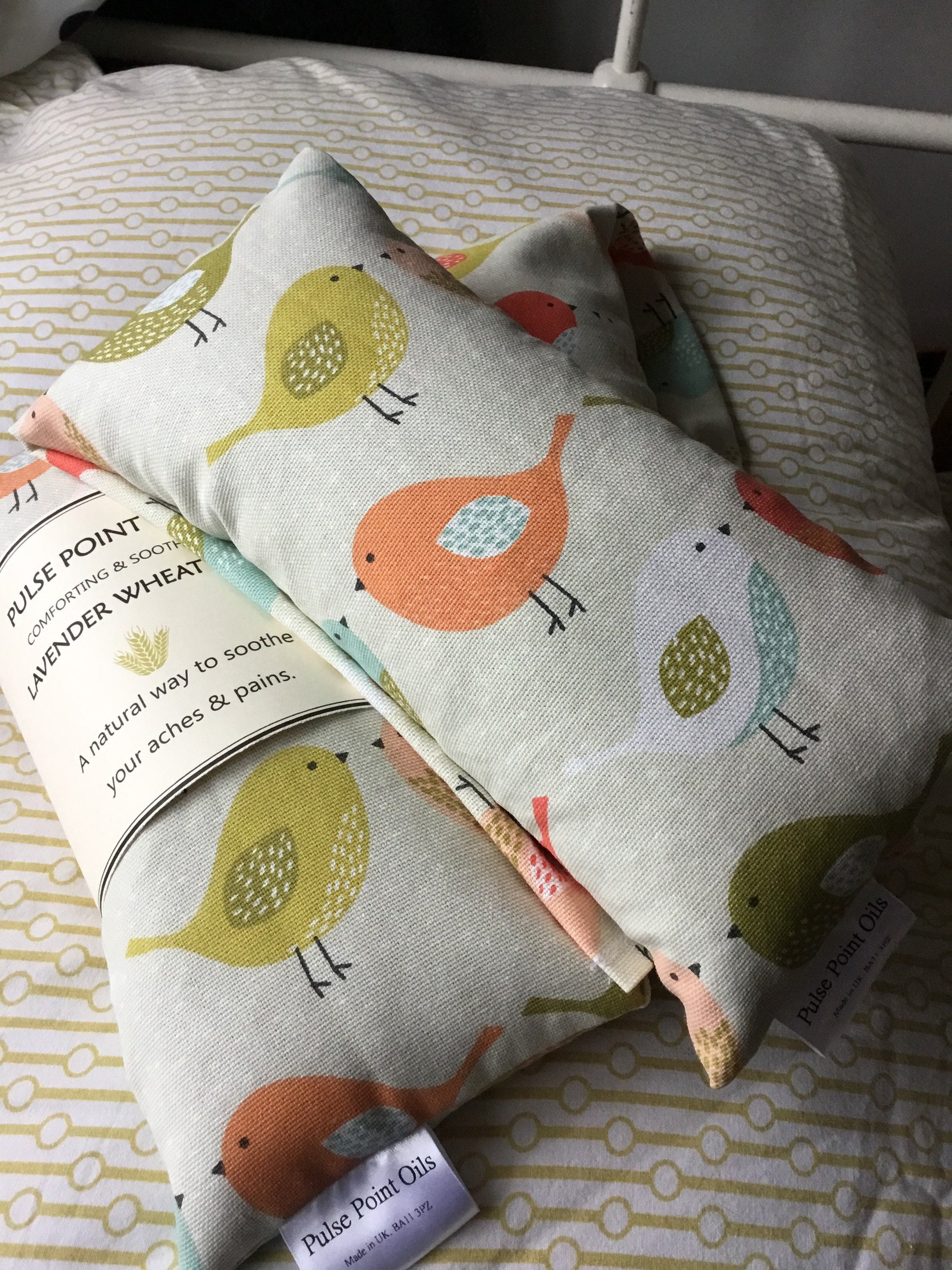 children's body warmer wheat bag in a lovely printed cotton with orange, yellow, green and cream chicks on a pale  cream background