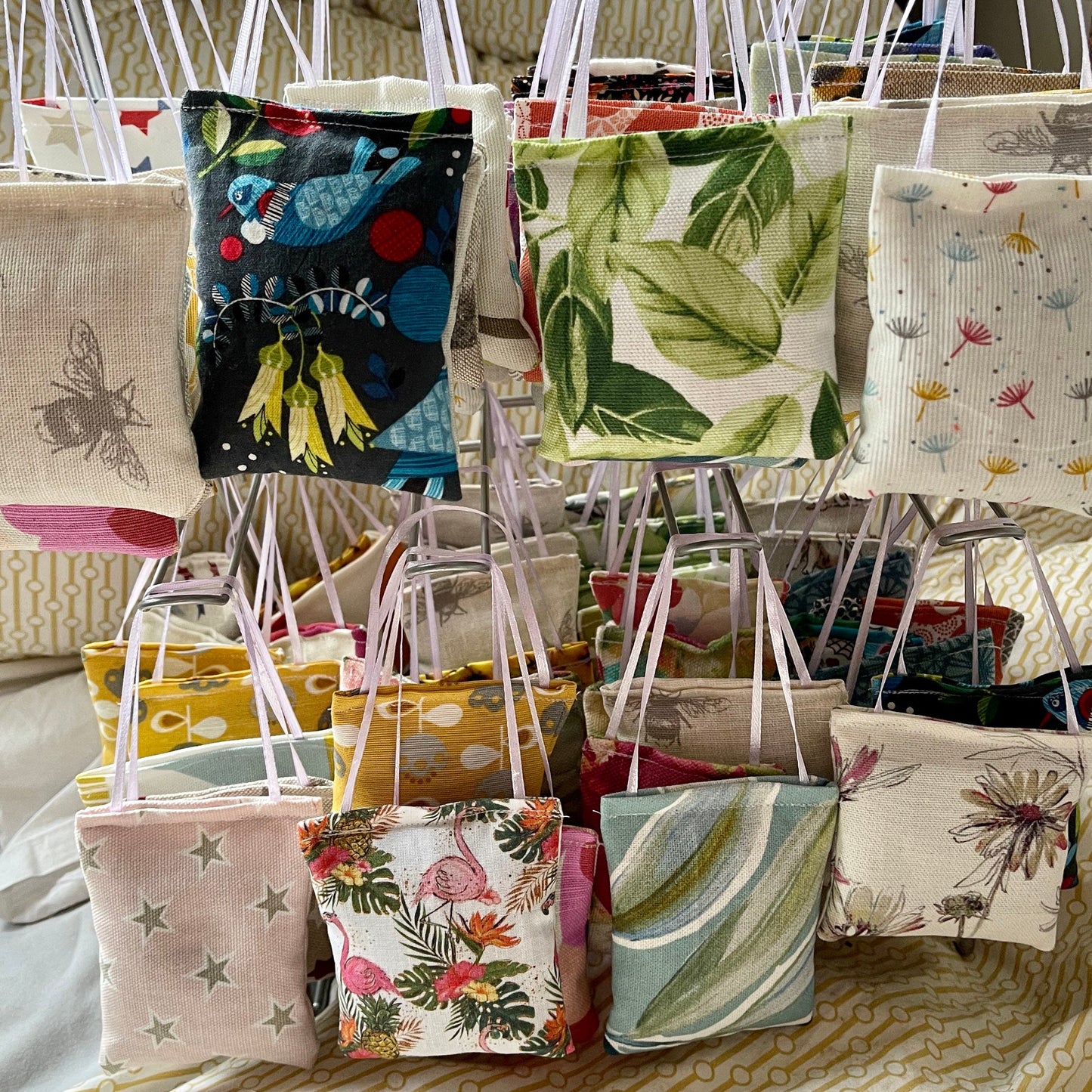 random mix of lavender filled sachets used as pocket hugs, sleep aid, draw freshener, bag freshener, each with a ribbon for hanging. will come in a set of four in a letterbox friendly postal box in a bag to protect it from the elements