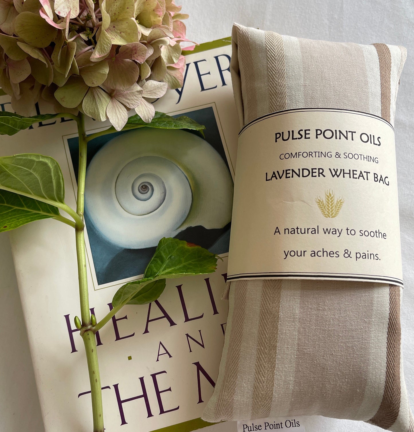 microwave wheat bag in a neutral cream mocha colorway. soothing and warming wheat bags or use as a cold compress when needed for pain, swelling and bruising