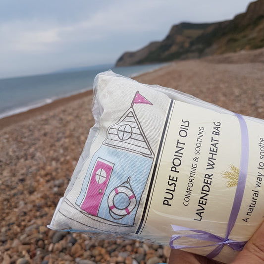 lavender wheat bag, beach hut print on a beach 