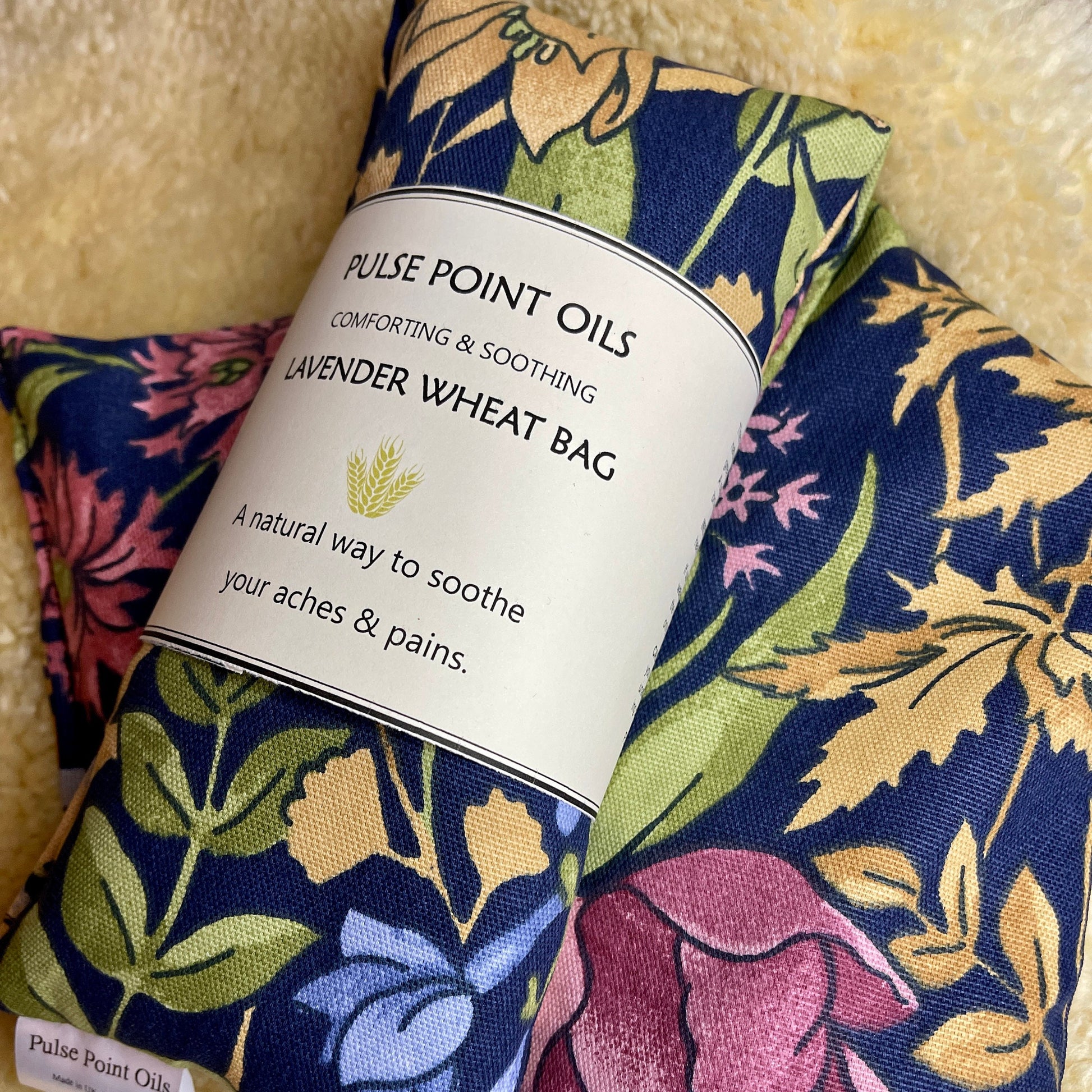 lavender scented hottie heat bag for neck and shoulders pain relief. Pretty florals on navy background wheat bags