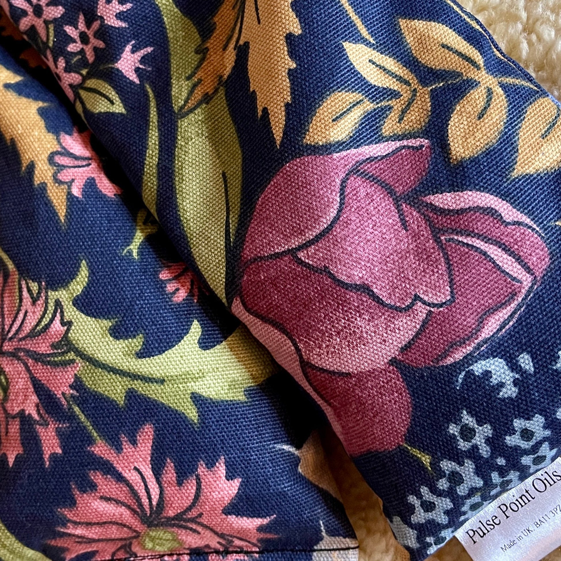 pink florals on navy background, midnight garden cotton print wheat bag for natural pain relief and relaxation