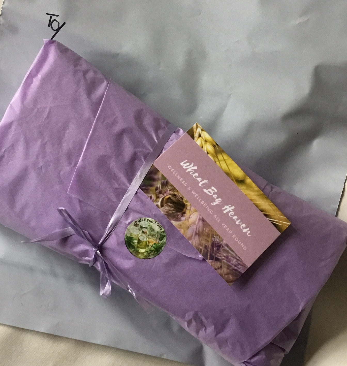 lilac wrapped red fern print wheat bag with lavender scent warming heat wrap for the gardener, handcrafted in Somerset