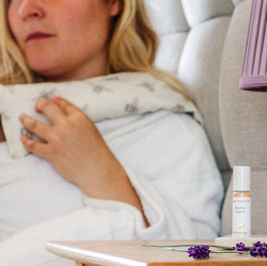 lady with a bee printed warmed wheat bag draped across shoulders enjoying its stress relieving benefits