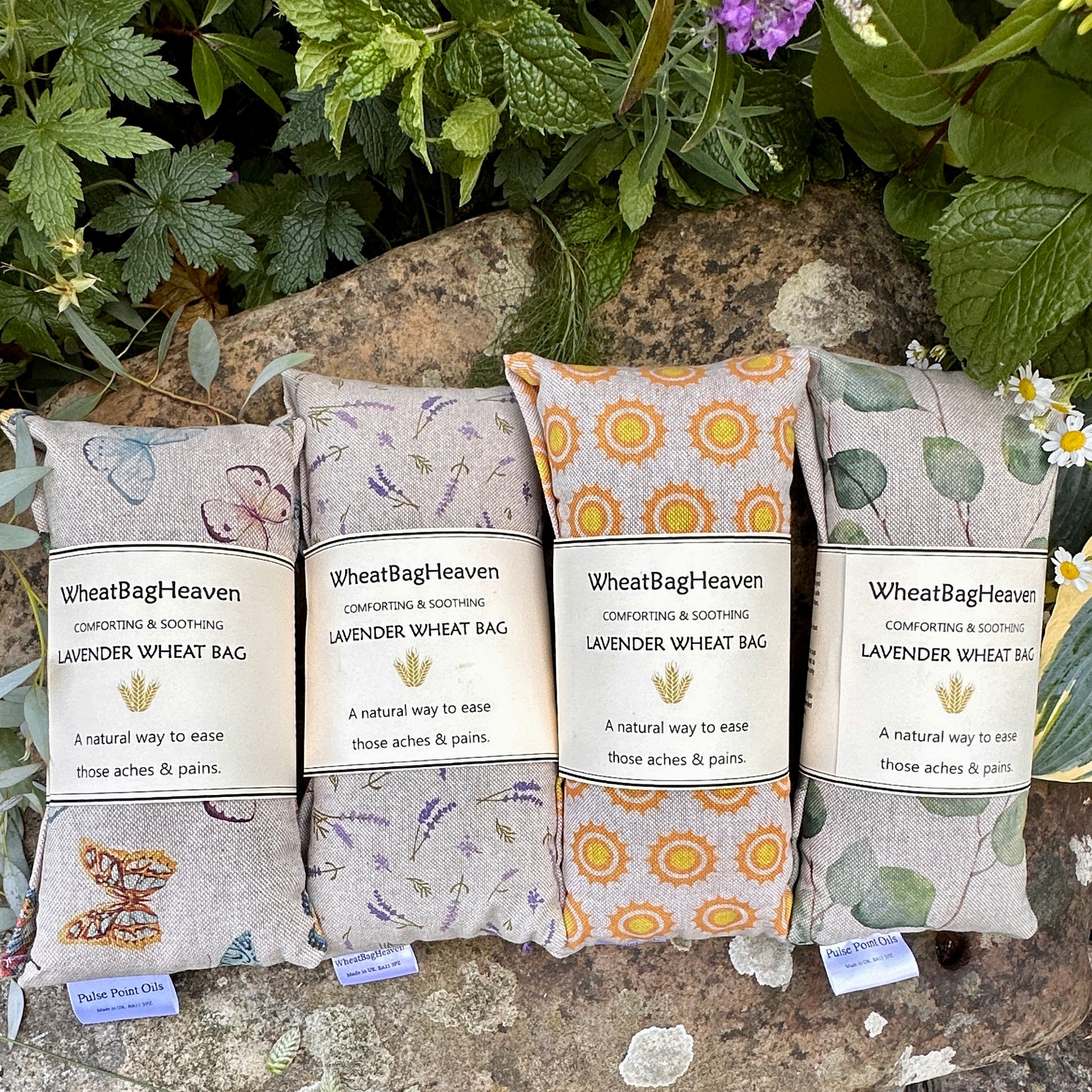 Lavender scented wheat bags, four in a row from left to right is a beautiful butterfly print on beige background, then small lavender sprigs printed on beige cotton background, cheery sunshine print and lastly gorgeous eucalyptus leaves print all 47x12cm long enough for necks, backs, joints. Relaxation and pain relief from wheat bag heaven.