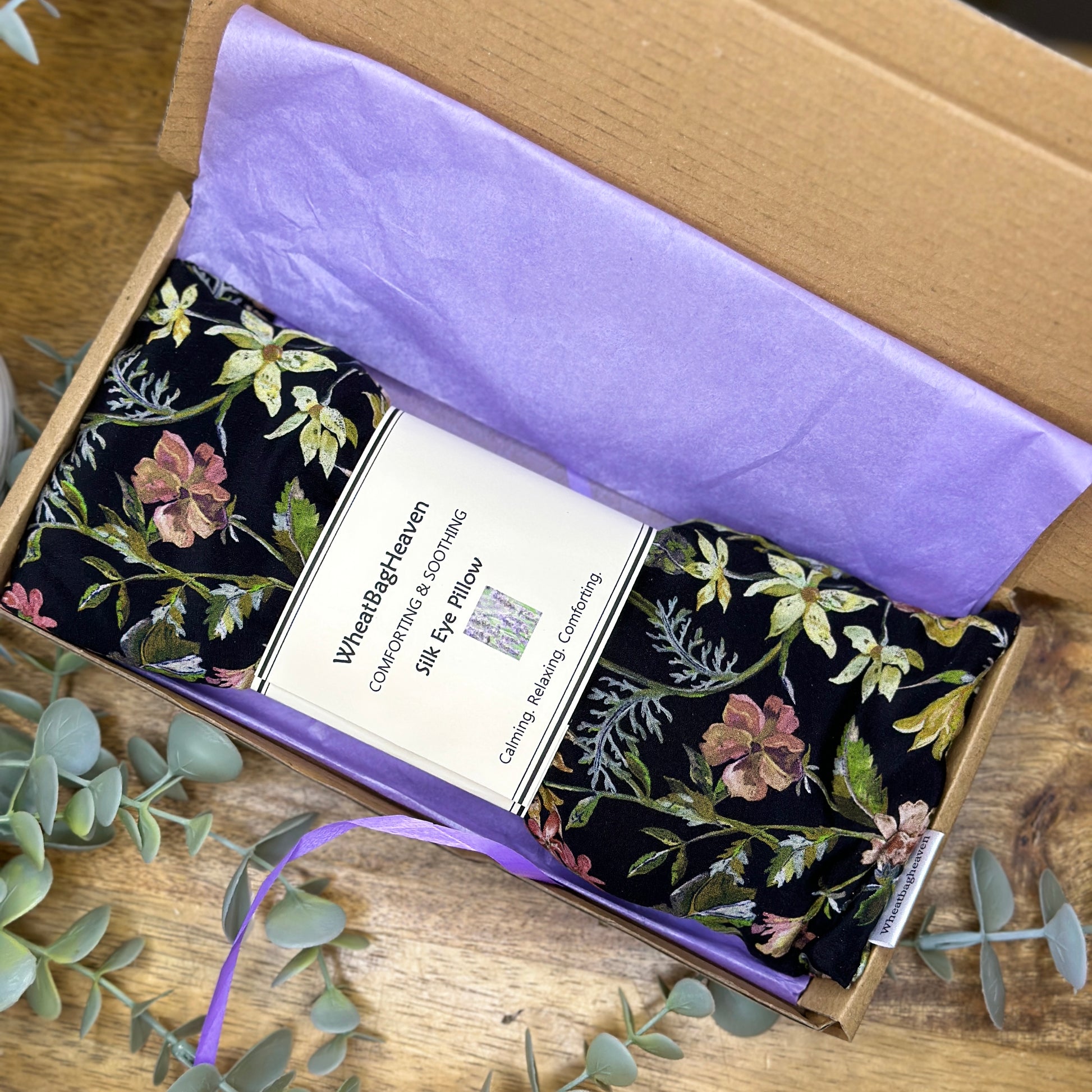 Black silk floral eye pillow in a letterbox sized box with tissue paper and ribbon ready to post gifts from wheatbagheaven.com