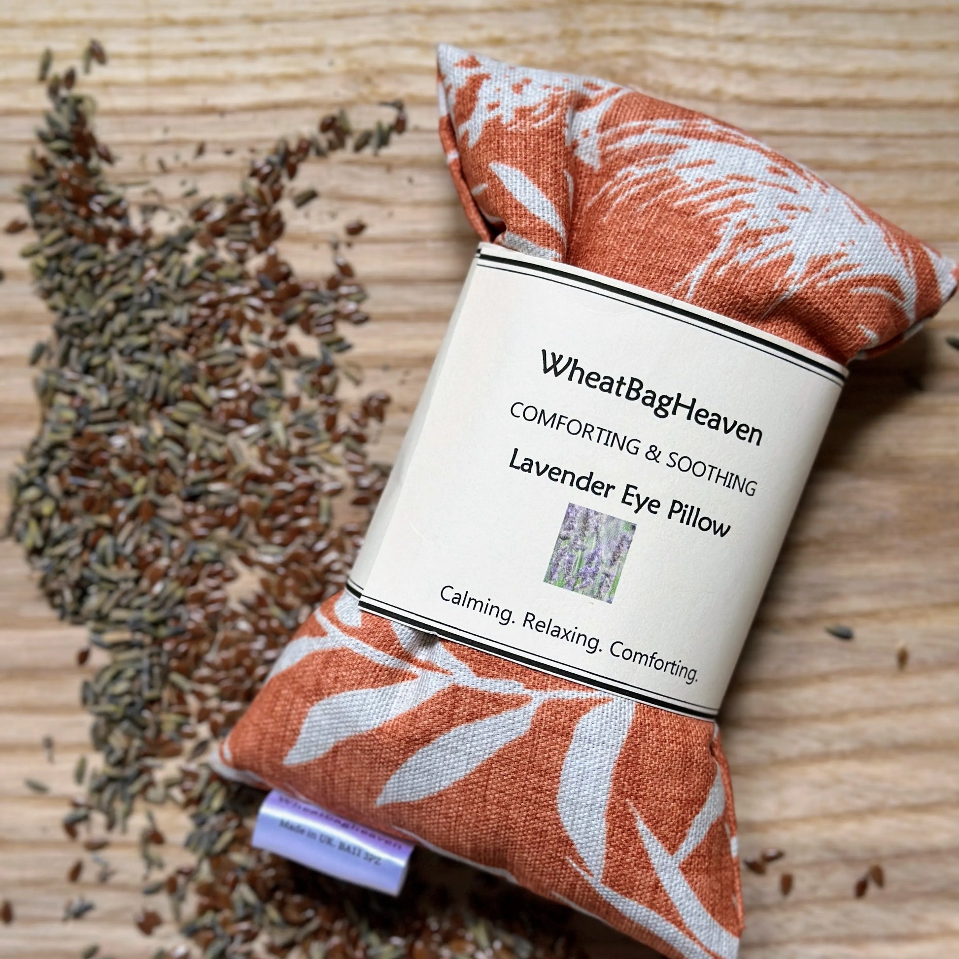 orange eye pillow with botanical grass print filled with flaxseed and dried lavender