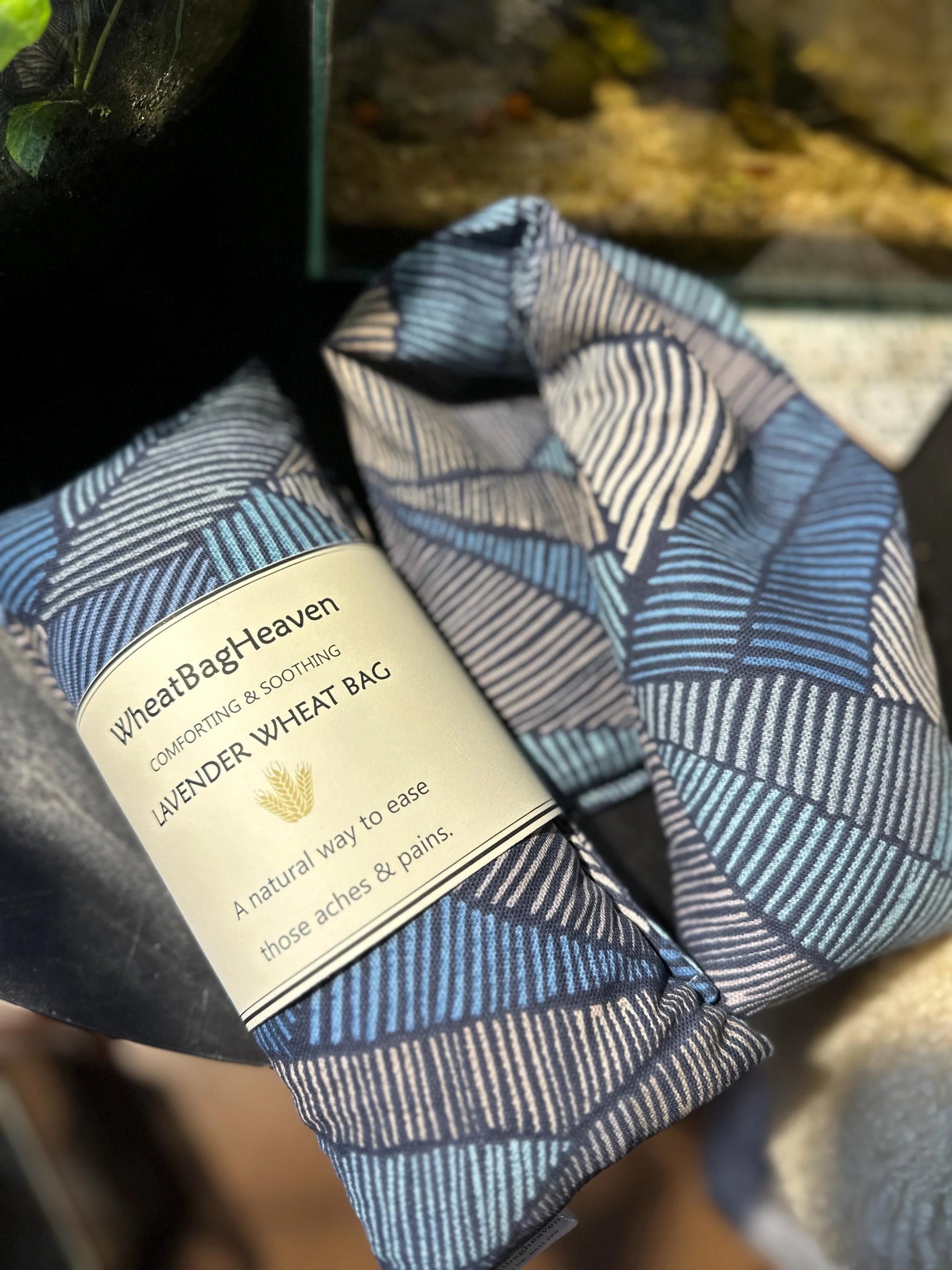 handmade masculine navy and black Aztec Abstract print wheat bag in a quality cotton fabric. This microwavable heat pack is the perfect practical gift for the man who deserves a moment of relaxation and self-care.
Hand filled with British wheat and English lavender, and labeled WheatBagHeaven comforting and soothing Lavender Wheat Bag. A natural way to ease those aches and pains