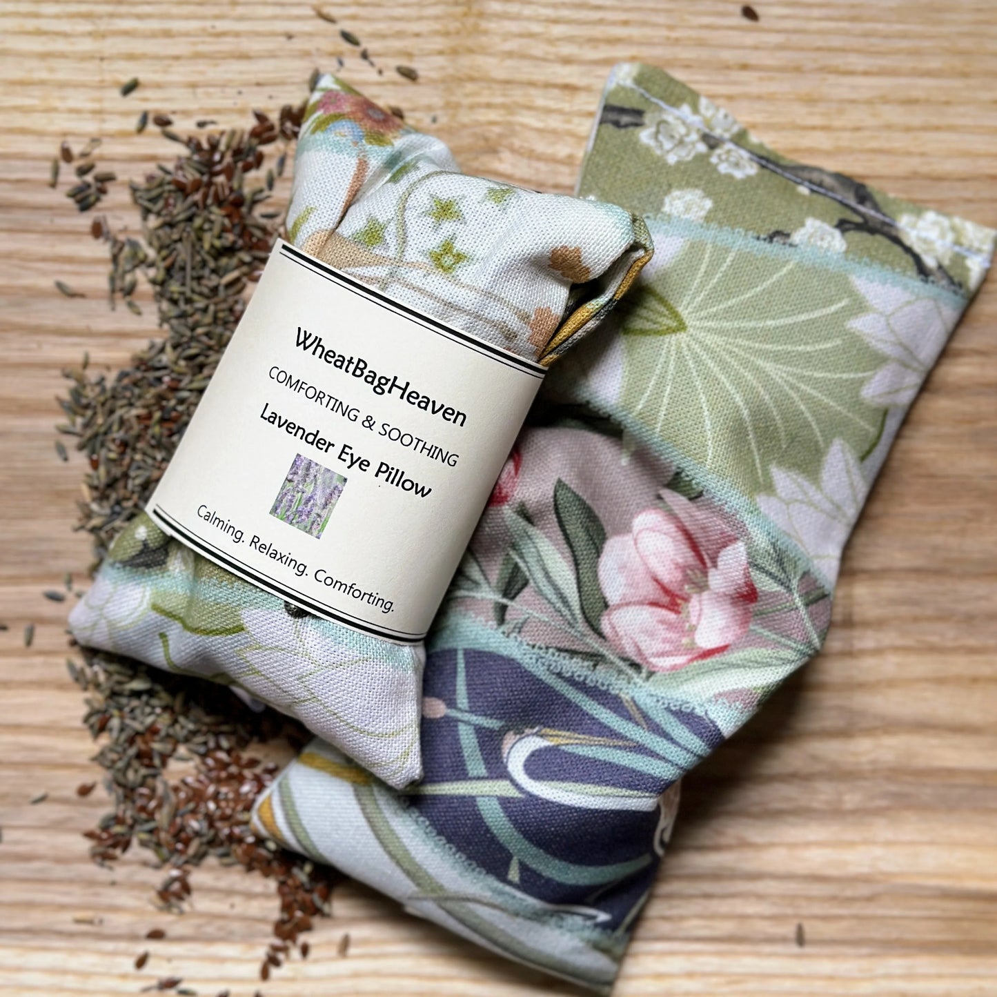 pair of lavender eye pillows in cotton chateau collection on wooden backdrywith organic flax seed and English lavender handcrafted by WheatBagHeaven 