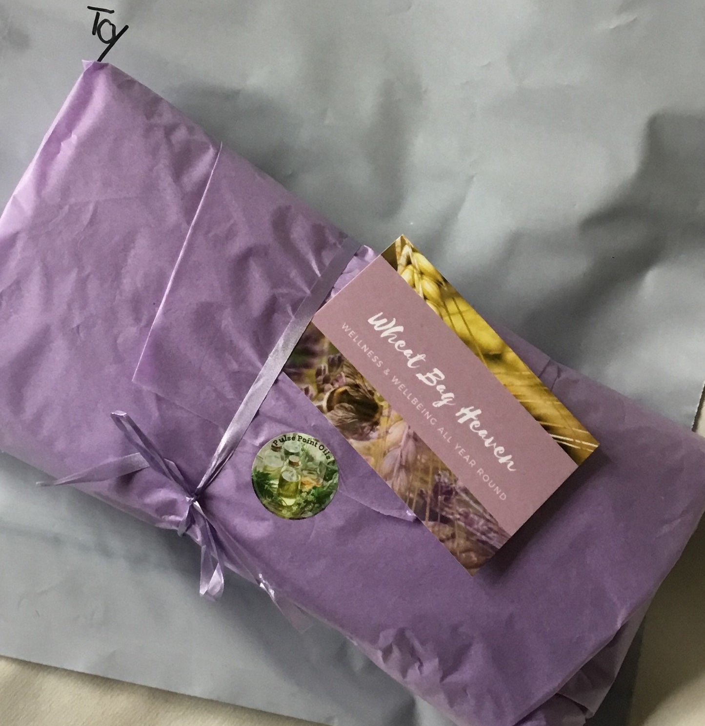 purple tissue paper wrapping on lavender scented, long cotton wheat bag