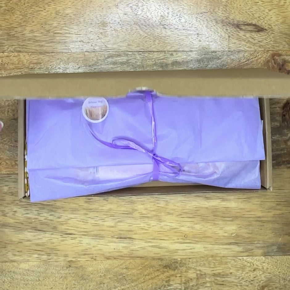 short video opening a box, unwrapping and revealing a beautiful silk yellow floral eye pillow from wheatbagheaven.com