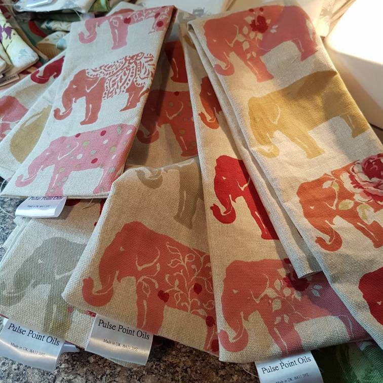 Long cotton wheat bags for wellness, Elephant print in spicy orange, pinks and reds. from wheatbagheaven