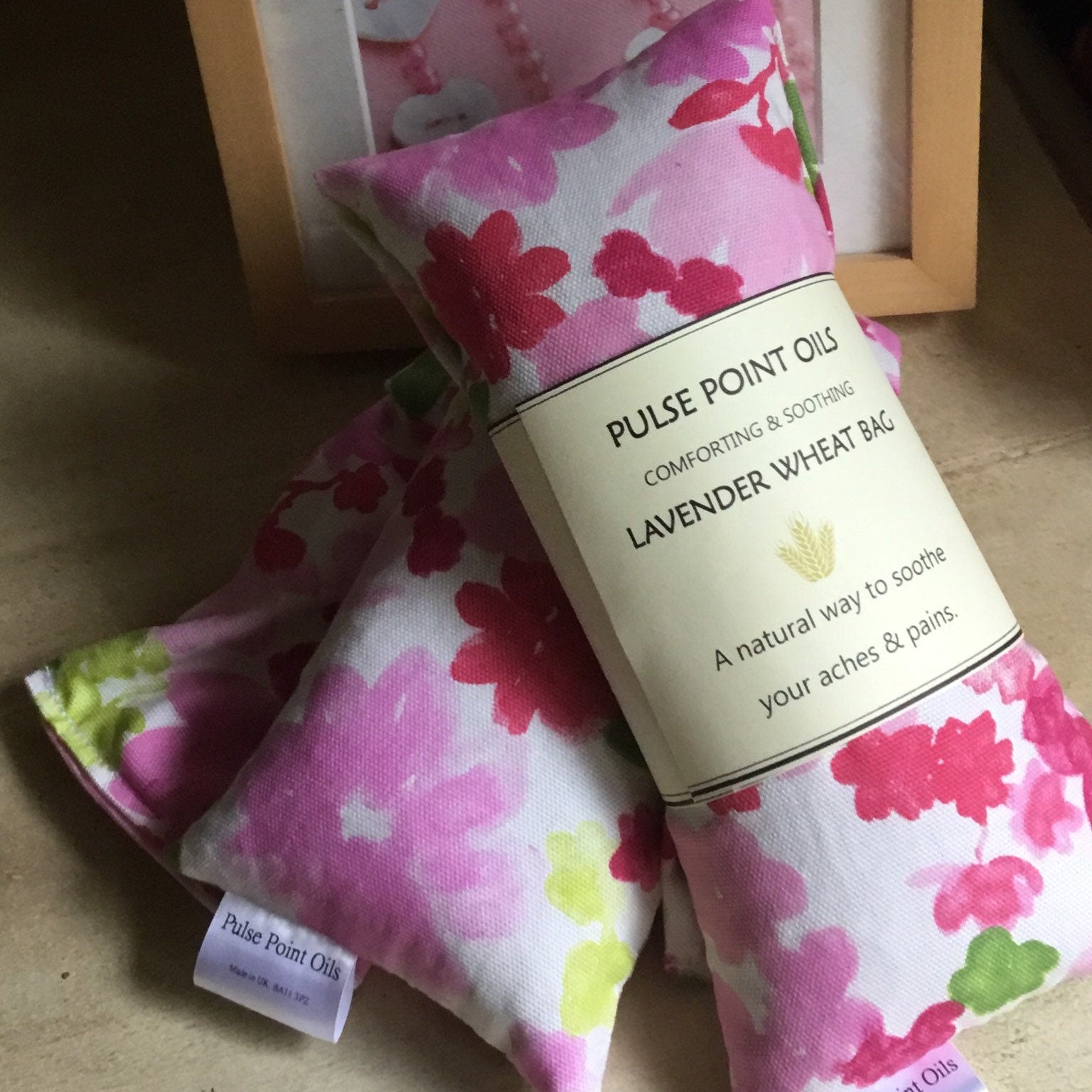 Two lavender scented wheat bags from WheatBagHeaven in a pink peony print cotton fabric