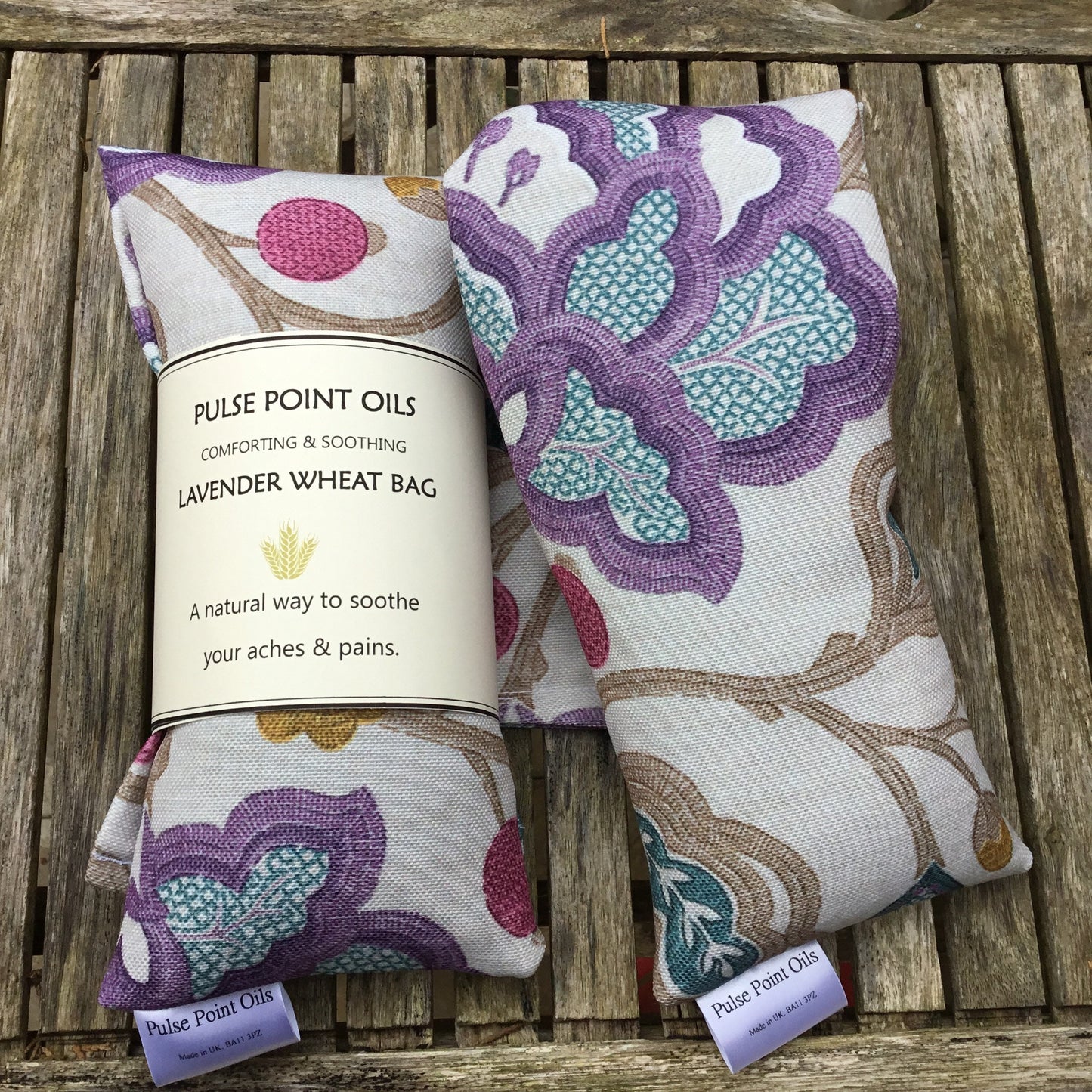 two Lavender scented wheat bags. Heat pad body warmer. Magnolia with purple, pink and blue print. 