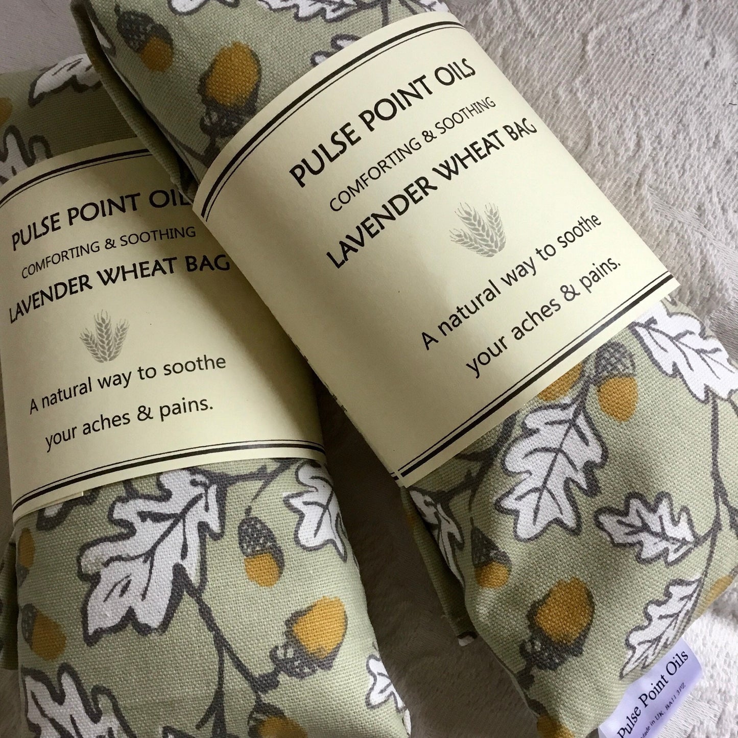 Two long wheat bag in acorn wood print, lavender scented heating pad