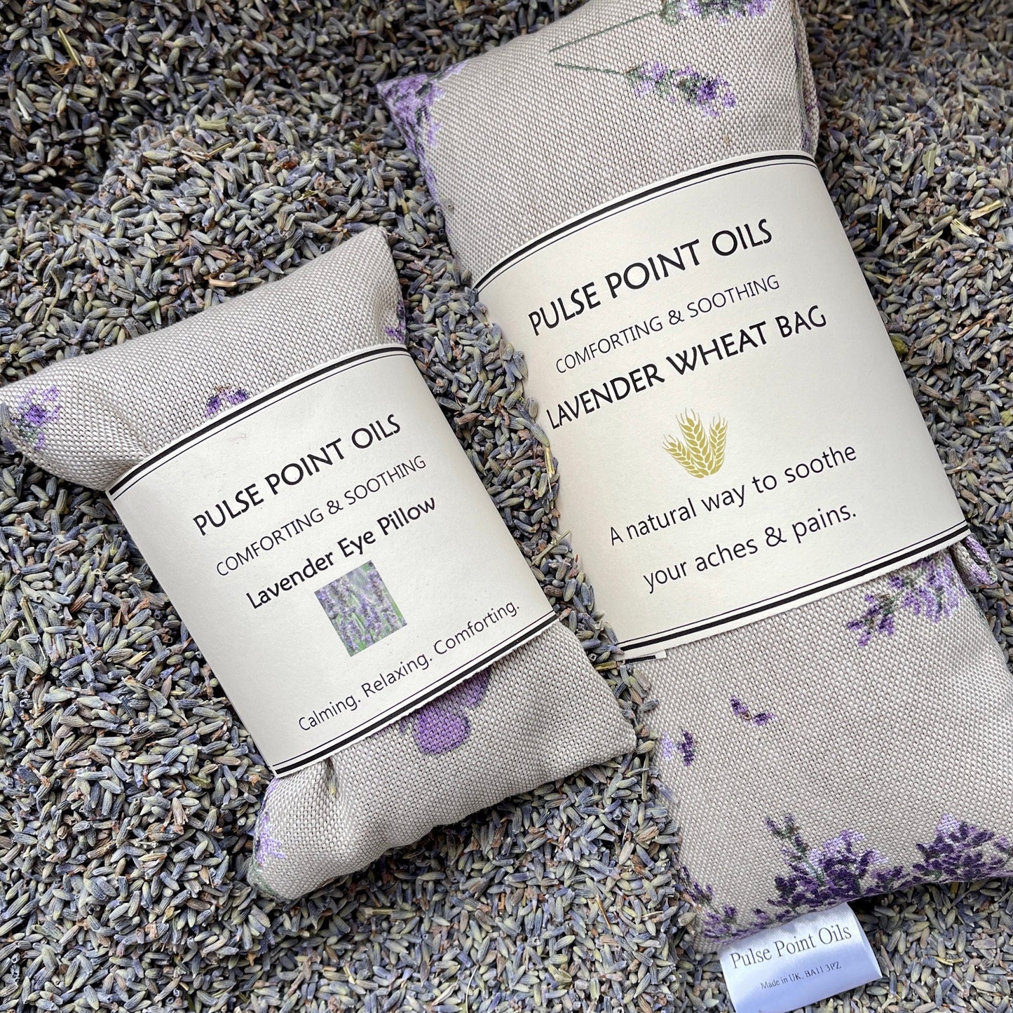 Lavender scented long cotton wheat bags and eye pillows with a lavender background. wellness gifts for mum, perfect hamper filler from wheatbagheaven