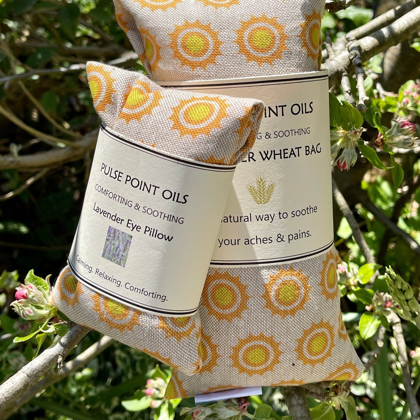 Eye pillow in sun print cotton fabric alongside a long lavender and wheat filled heat wrap from WheatBagHeaven 