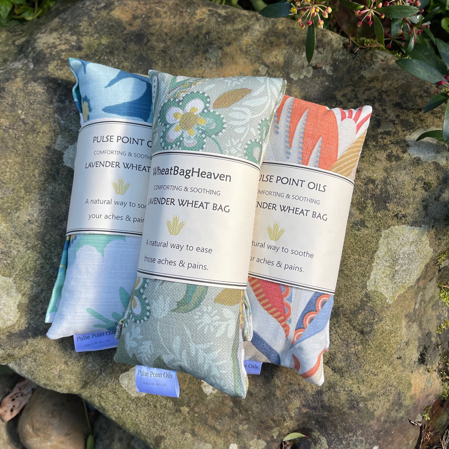 A trio of lavender scented microwave wheat bag heating packs. Cotton fabric folklore, zumbia and leon tulip