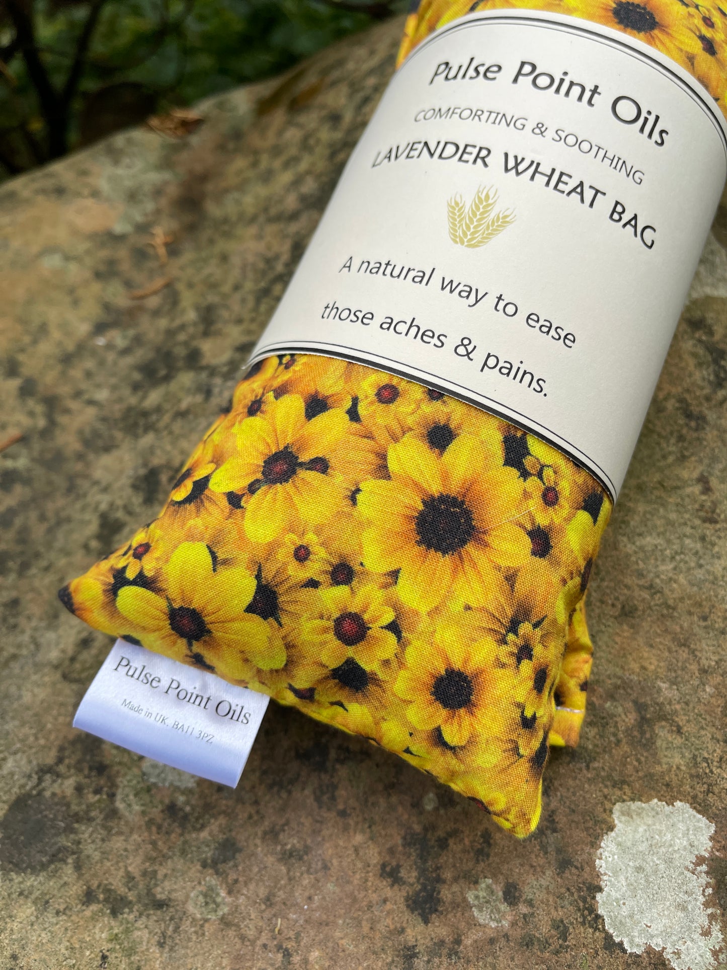 Warming wheat bag with lavender buds for natural pain relief, made in a lovely sunflower cotton print from wheatbagheaven. Ready to post wellbeing gift